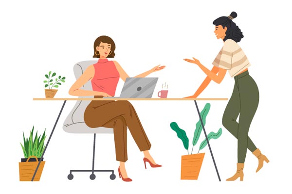 Ilustracija dviju poslovnih žena koje razgovaraju u uredu pored radnog stola s prijenosnim računalom