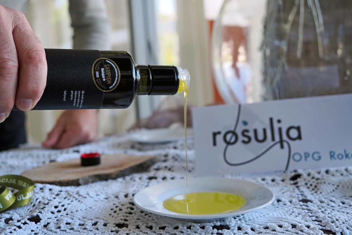 Točenje nagrađivanog ekstra djevičanskog maslinovog ulja OPG Rošulja u plitki bijeli tanjurić